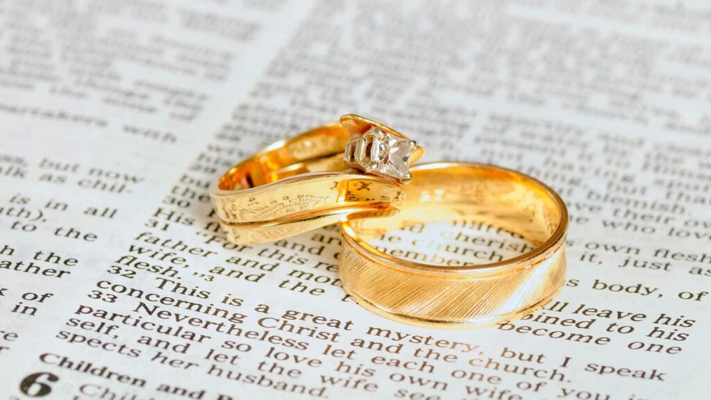 Wedding rings placed on an open Bible